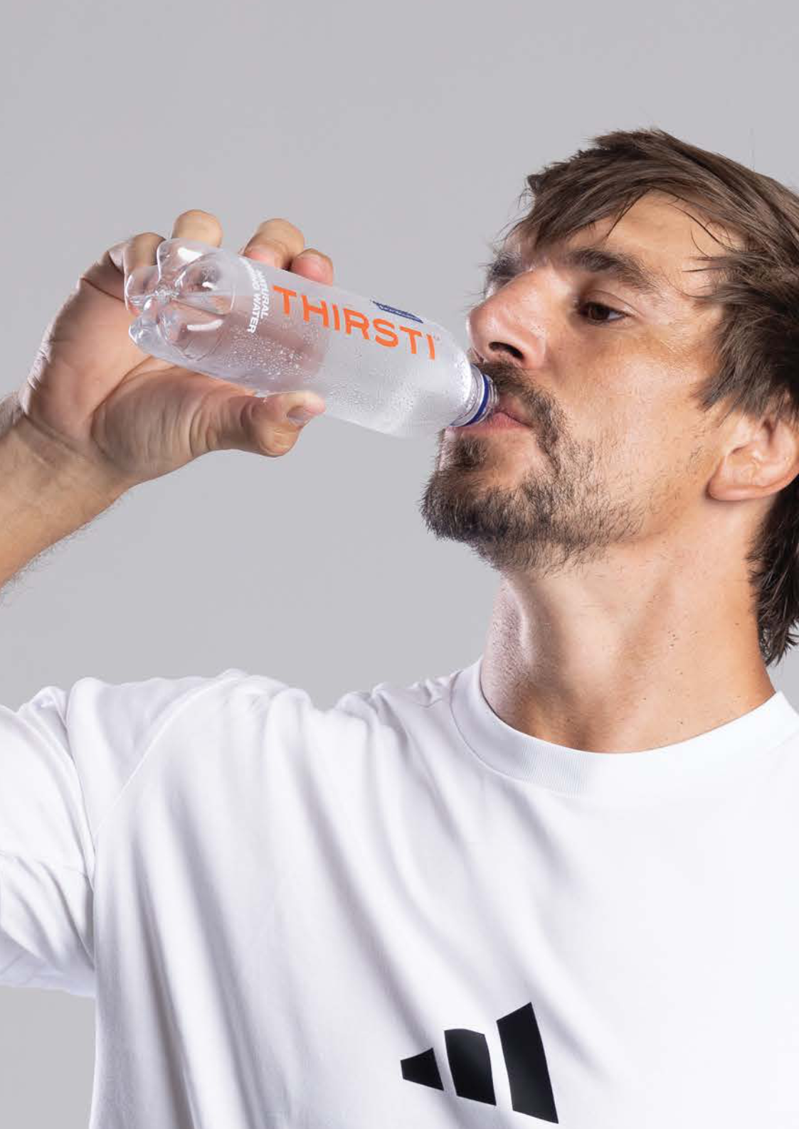 Athlete drinking THIRSTI Natural Spring Water